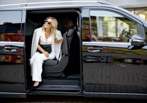 A woman exits a van from MC Cabs, one of the taxicab companies Peoria IL trusts