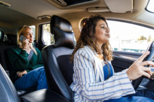 Taxicab Companies Peoria IL 1 A driver from MC Cabs, taxicab companies Peoria IL trusts, drives with a passenger in the backseat
